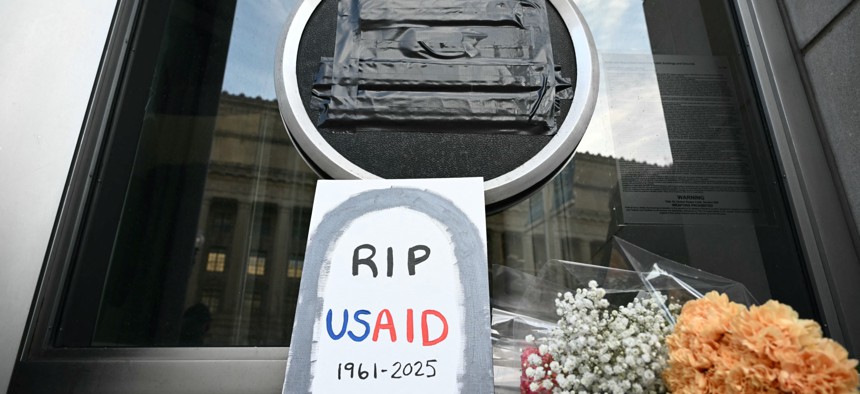 Tributes are placed beneath the covered seal of the U.S. Agency for International Development (USAID) at their headquarters in Washington, D.C., on Feb. 7, 2025.