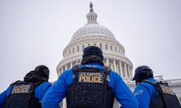 U.S. Capitol Police officers stand guard in a winter storm in the nation's capital on Jan. 6, 2025 in Washington, D.C. Two federal law enforcement employee associations are arguing for stronger exemptions to proposed benefits cuts.